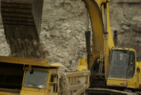 Excavator loading haul truck.