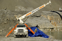 Installing tarp barrier.